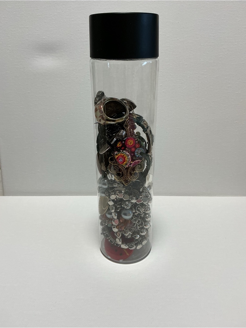 Clear Jewelry Tube Filled with 25 Mixed Costume Jewelry Multicolor Items.